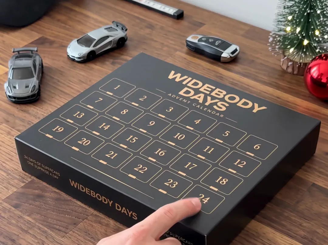 Widebody Days advent calendar on a walnut desk